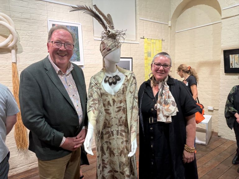 Dr Michael Holland Member for Bega with the winner of the 2025 River of Art Prize Lilaea van der See and her work