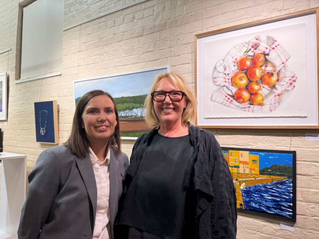 Sponsor Sarah Roberts from Community Bank Batemans Bay with River of Art Chair Corin Roussouw and second place artwork The Stolen Pomegranates 2024’ by Felicite Bigge